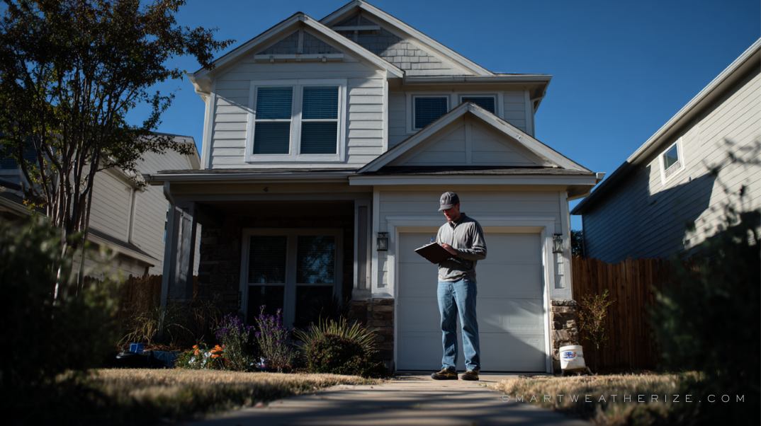 Person inspecting windows and roof for gaps and weather damage with a clipboard in hand